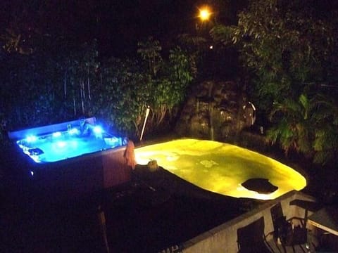 All lit up at night, 8 Person Hot Tub, Waterfall, and Koi Pond.  