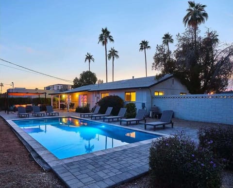 Stunning private yard with sparkling pool (pool heat available), sun loungers, cabana, fire pit, covered patio, and outdoor dining.