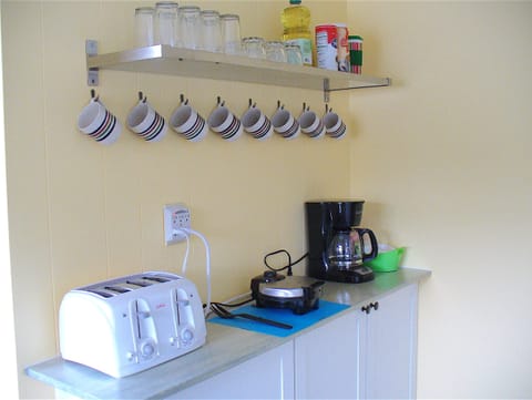 Coffee nook supplied with Coffee, sugar, creamer.  Waffle maker, mix, and syrup.