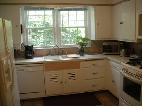Kitchen w/ Corian countertop, marble, convection oven, fridge with ice and water