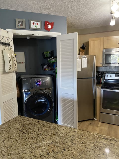 GE Profile Washer/Dryer Combo Laundry Closet in kitchen area.