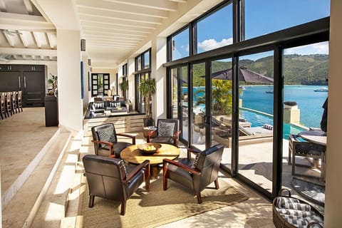 The sunken area of the living room, adjacent to the pool deck.