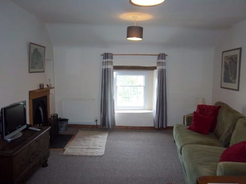 Spacious lounge with freeview television and working open fireplace.