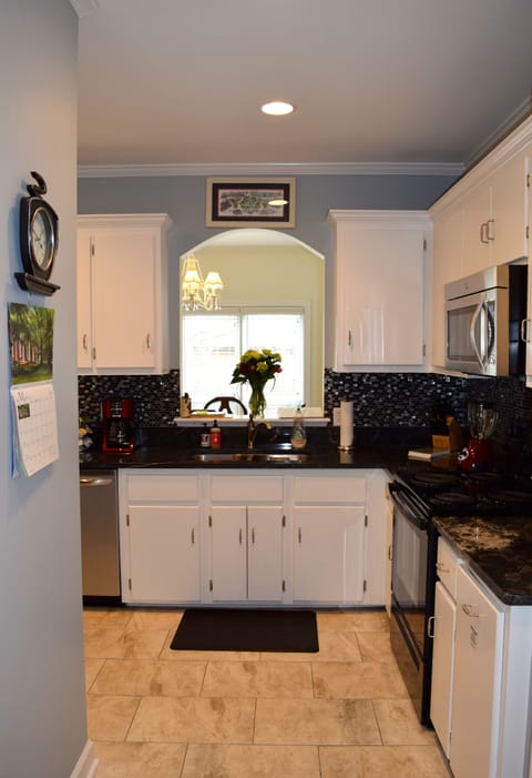 The fully-stocked kitchen provides utensils, dishes, and cleaning supplies.