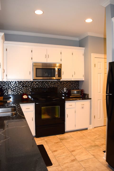 Our beautiful kitchen boasts a unique granite slab countertop.
