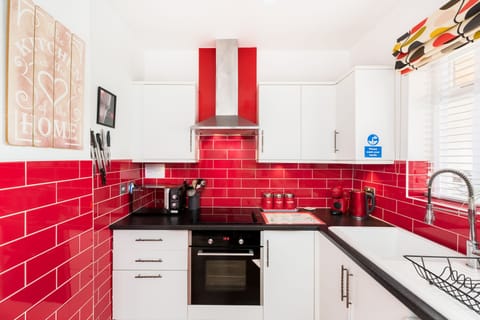 Modern Kitchen with dishwasher, ceramic Hob, fridge, mixer tap & coffee machine.