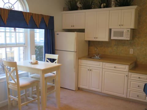 kitchenette with full size refrigerator and table for 2