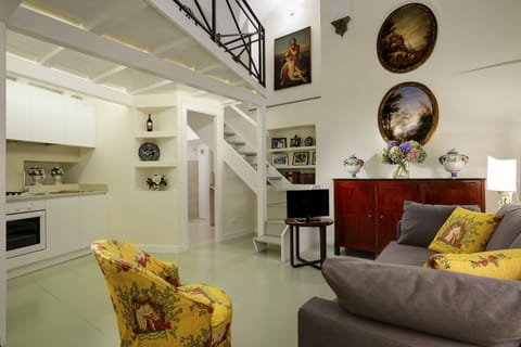 Living Room with double sofa bed, armchair, TV and full kitchen.