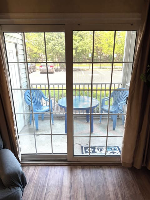 A screened in porch with seating for 4