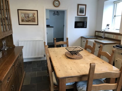 Dining room showing the kitchen in the background.