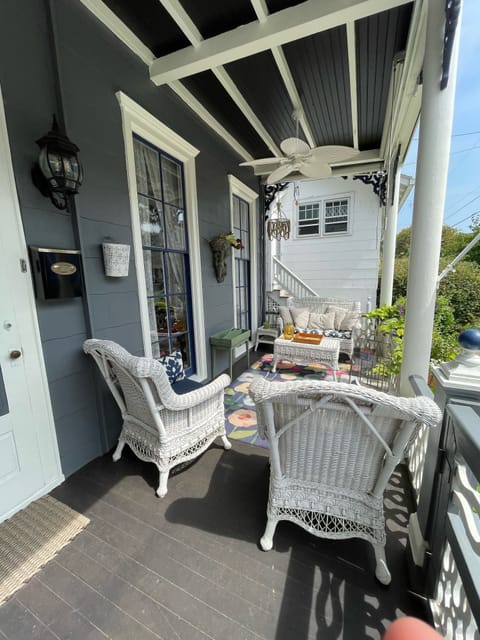 Front first floor porch with mahogany, roller shades, chandelier and ceiling fan