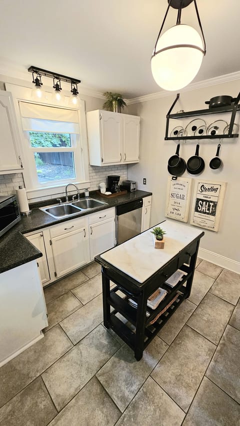 Kitchen has a dishwasher and full set of cookware