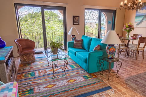 Living and dining area, balcony in background.
