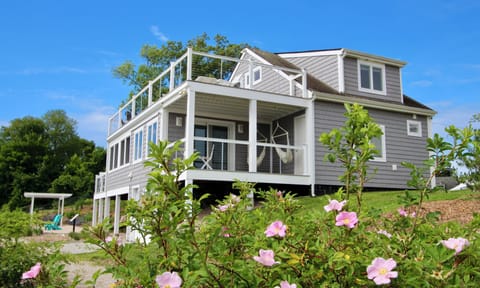 Waterfront home with three decks overlooking the ocean cove.