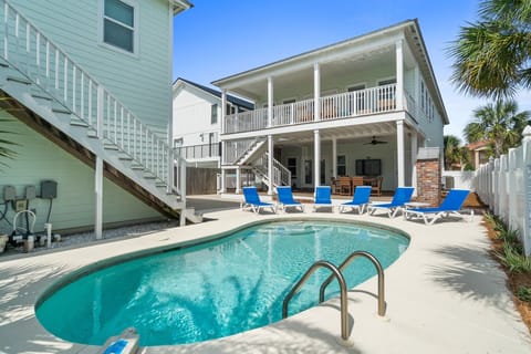 Private pool with balcony and covered outdoor kitchen/dining space.