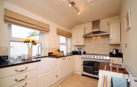 Kitchen with large range cooker and two ovens. Belfast sink. Dishwasher