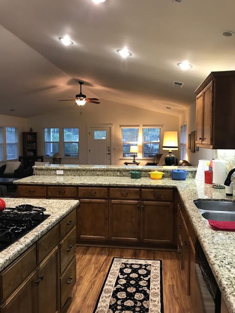 Spacious kitchen is centrally located so the cooks can both work & visit!