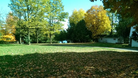 Looking down the property to the lake in early fall with cottage on the right.