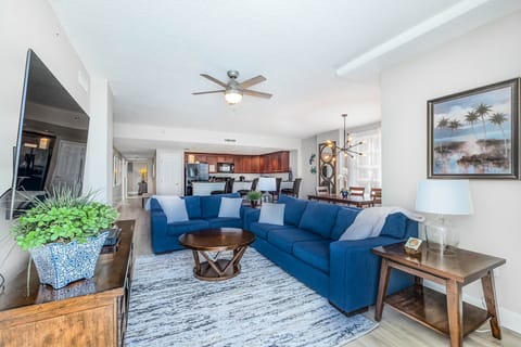 Living room with sofa and loveseat, wall mounted 65" 4k smart tv. 