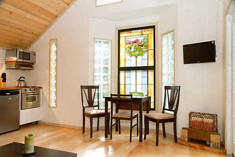 The living room features an antique stained glass feature window.