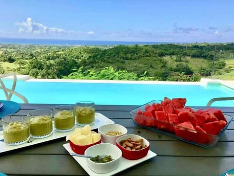 Vila Vertigo overlooks the atlantic ocean and green hills.