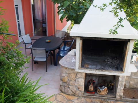 Outside fireplace, free to use and entrance to the apartment

