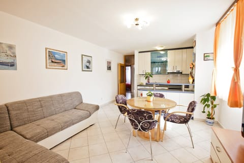 Living area with large sofa that can be used as comfy bed for two persons