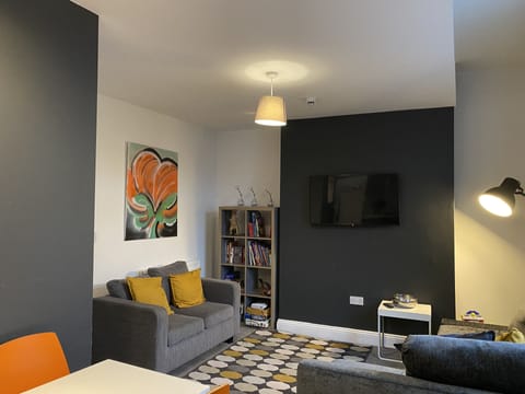 Open Plan Living area with Smart TV, books and children's toys. 