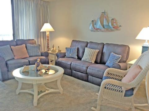  Leather sofa & love 
seat with 3 recliners, bar,
and entry to porch.