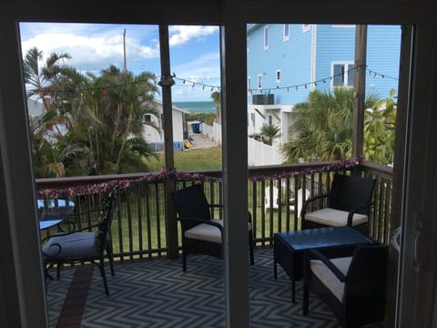 In-home view of Blue Water of the Gulf of Mexico and people walking along beach