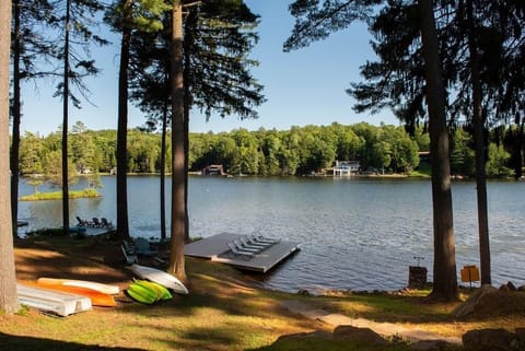Waterfront with fire pit and dock.