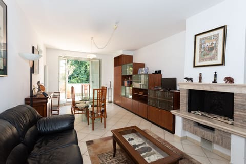 Living room with fireplace. The window door directly accesses the large terrace