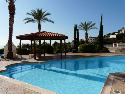 Swimming pool belonging to the apartments also
showing BBQ area.