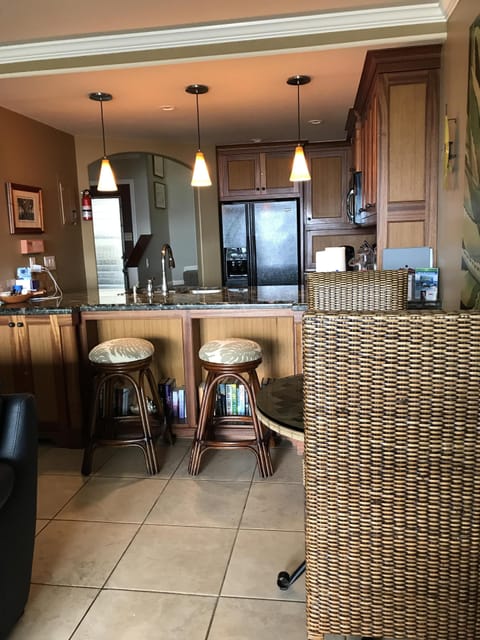 View into eating nook/bar and kitchen