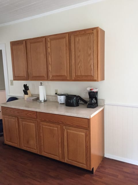 Service counter with appliances like coffee maker, toaster, microwave . 