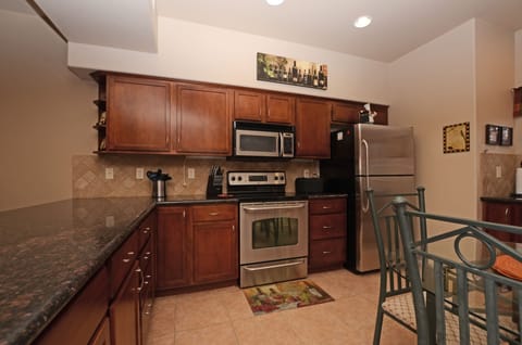 Fully stocked kitchen with Stainless steel appliances.