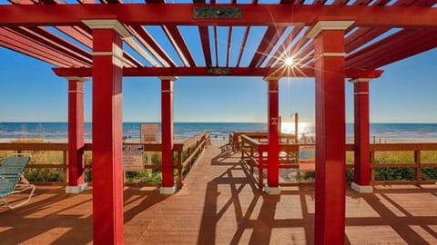 STEP OUT THE BACK OF THE BUILDING, YOU WILL SEE A BEAUTIFUL WHITE SAND BEACH.