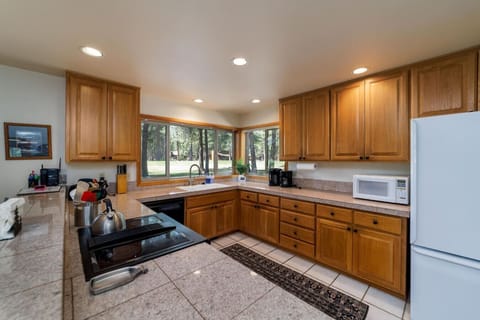 Ample granite counter space and fully appointed kitchen with everything you need for home cooking.