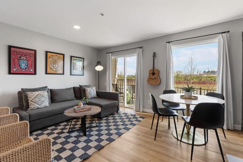 Living room with pullout sofa, dining table for 4, electric fireplace plus private patio overlooking the river!