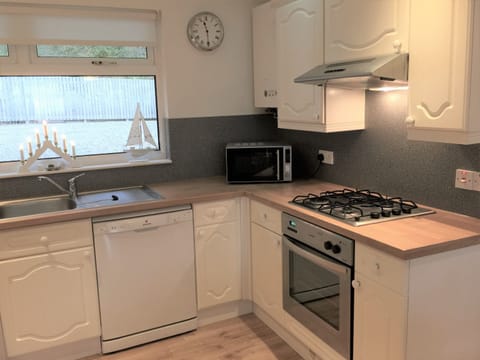 Kitchen equipped with dishwasher, washing machine, fridge-freezer etc.