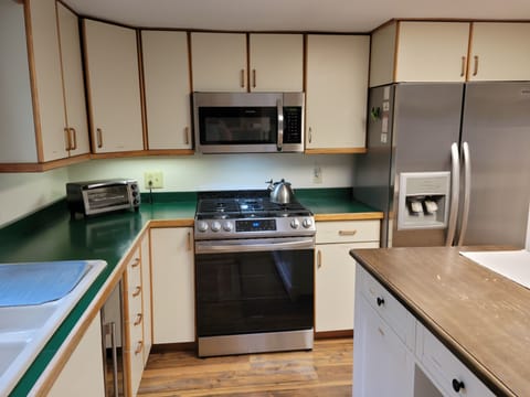 Kitchen with new gas stove and new microwave.