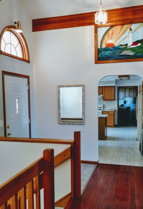 Front entryway with stained glass transom window.