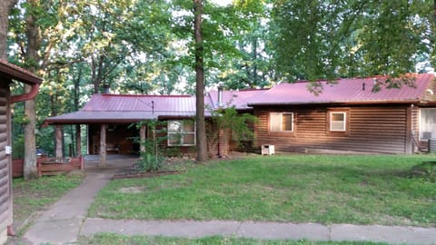 The Cabin in the Cove nestled amongst majestic towering oaks in the Ozarks