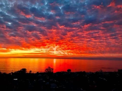 Sunset view from private rooftop oceanview cocktail, dinner, breakfast deck.