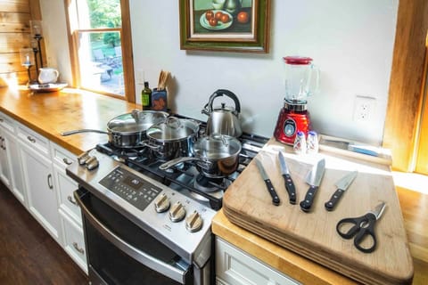 Fully outfitted kitchen with a 5-burner gas range, high-quality knives, cookware, an assortment of bakeware, and all the small appliances you need to cook for family and friends.