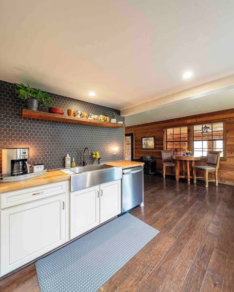 This galley style kitchen is roomy, perfect for lots of people cooking together. Guests who prefer to watch the action but be a part of the conversation will enjoy the seating area nearby.