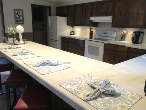 Kitchen with the utility room in the door way with a half bath.