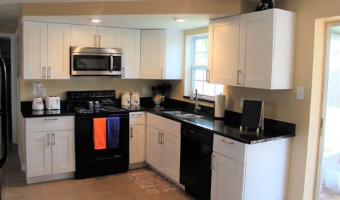 Kitchen with black granite and white bay cabinets