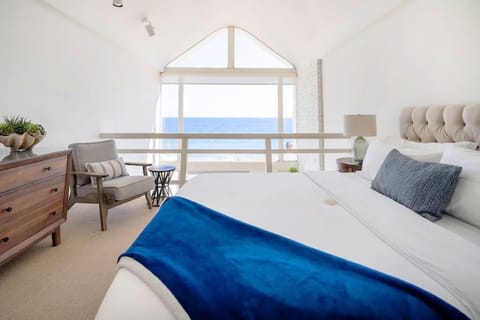 Primary bedroom has an oceanfront view, vaulted ceiling and en-suite bathroom