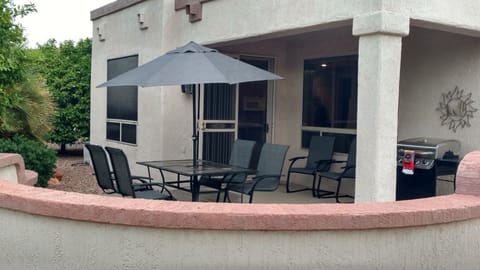 East/southeast facing patio area with dining, grill